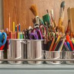 art supplies brushes rulers scissors pencils in stainless steel bucket