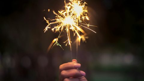 person holding lighted sparkler