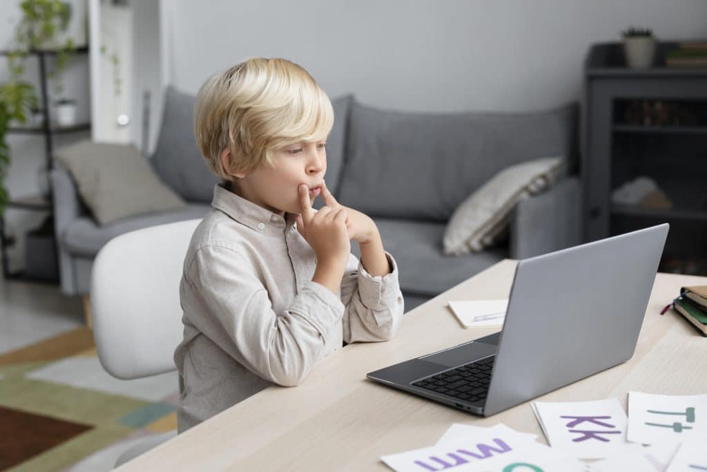 adorable little boy doing online session speech therapy
